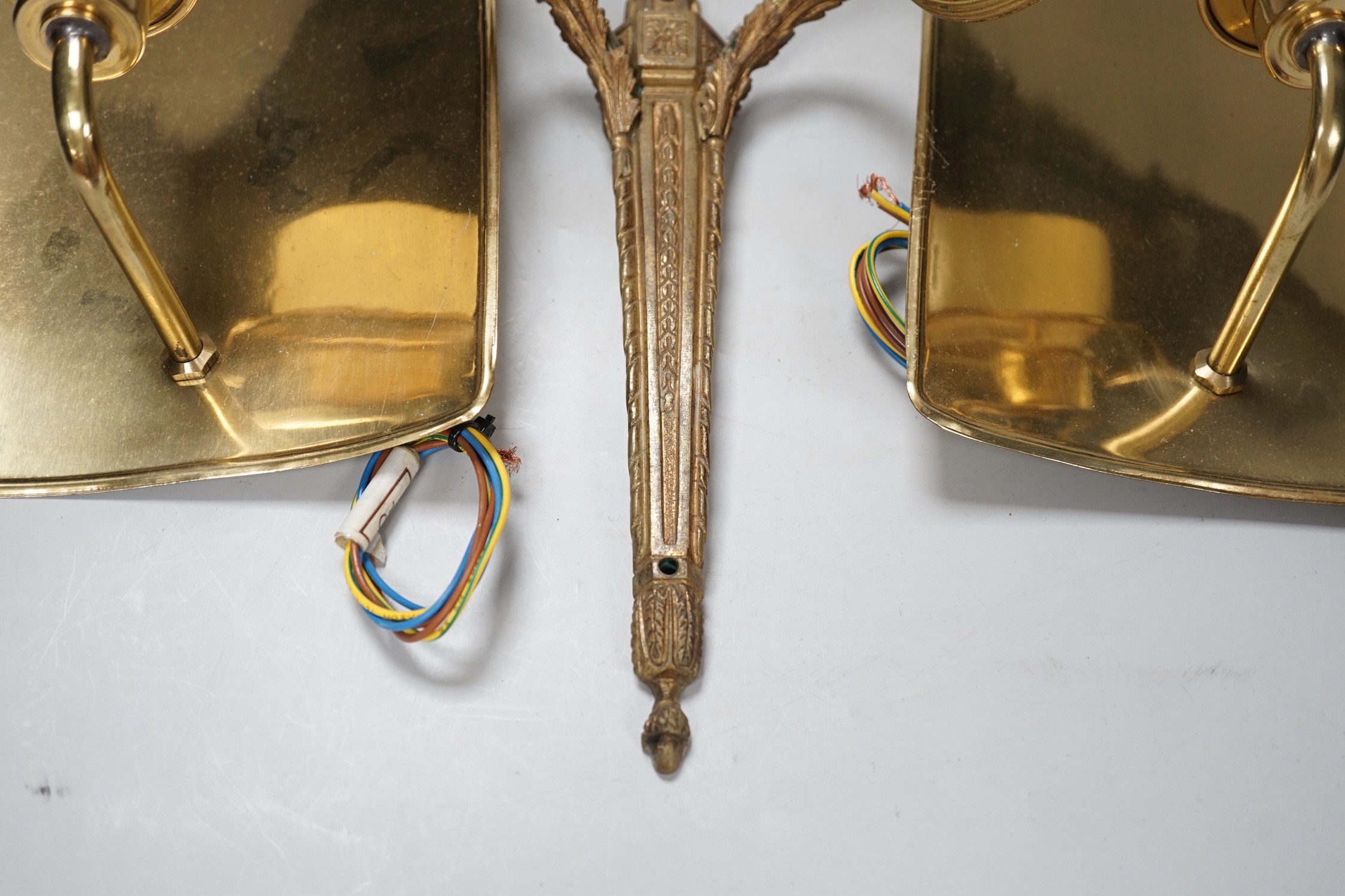 An 18th century style ribbon design brass two branch wall sconces and a pair of Dutch style brass wall lights, tallest 44cms high